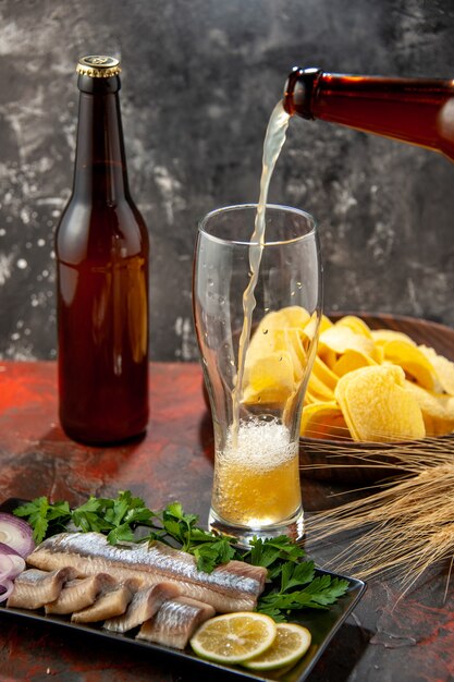 Vista frontale pesce fresco affettato con verdure e birra sulla foto scura spuntino carne farina di frutti di mare colore