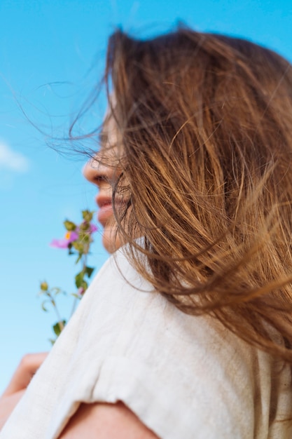 Vista laterale della donna con il fiore