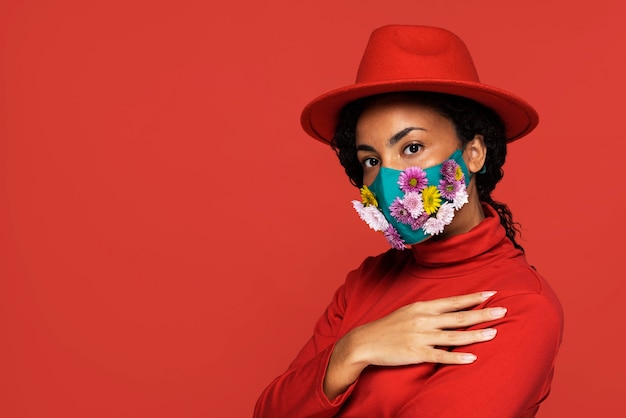 Vista laterale della donna con maschera floreale