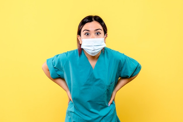 Vista laterale di un medico in maschera un medico in maschera chiede informazioni sul trattamento di pazienti con covid