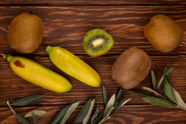 Vista superiore dei frutti della banana e del kiwi isolati su legno