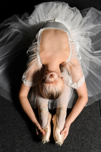 Vista superiore della ballerina in allungamento del vestito dal tutu