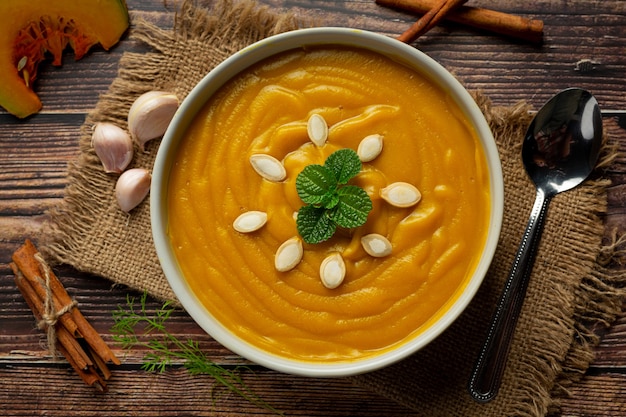 Zuppa di zucca in una ciotola bianca posta sul tessuto del sacco