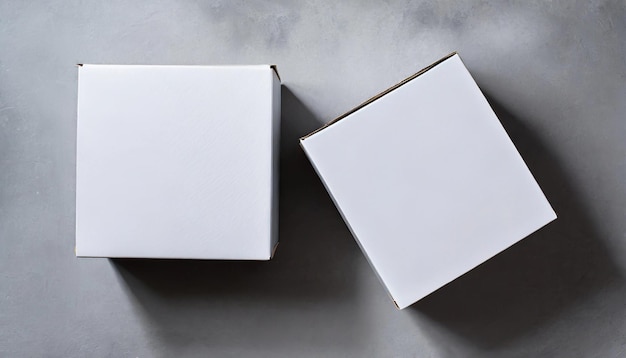 2 scatole bianche su uno sfondo di cemento Pacco di consegna Vista superiore piana