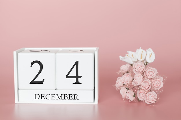 24 dicembre. Giorno 24 del mese. Cubo calendario su sfondo rosa moderno, concetto di bussines e un evento importante.