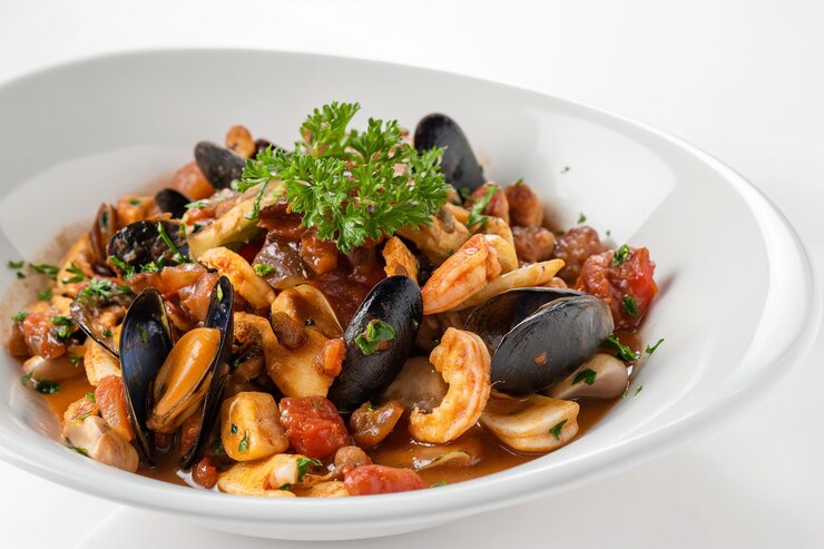 a bowl of food with mussels and mussels on it