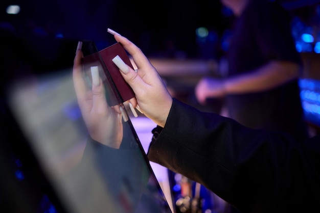 a close up image of a hand actively using a touchscreen device in a dimly lit environment