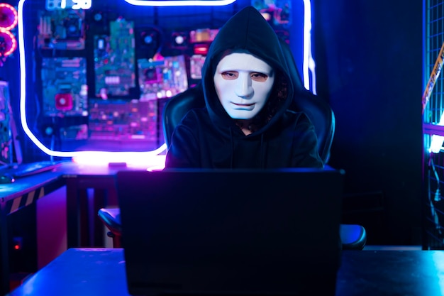 a hacker is using laptop computer to steal data in the night