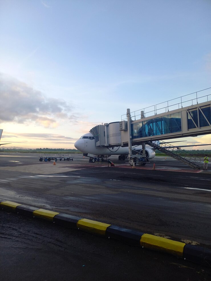 A plane is parked on the tarmac at the airport.