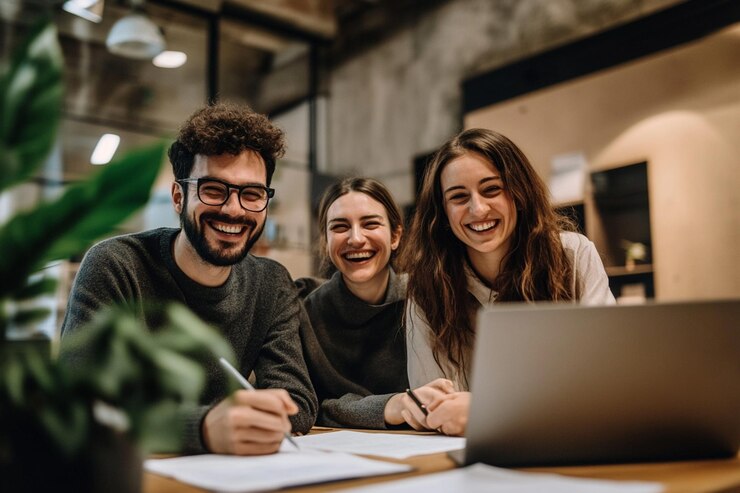 A team of coworkers smiling while reviewing docume