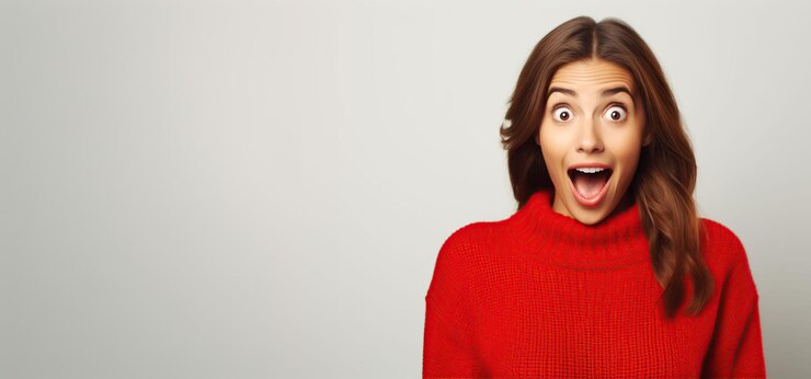 a woman in a red sweater is making a surprised face copy space