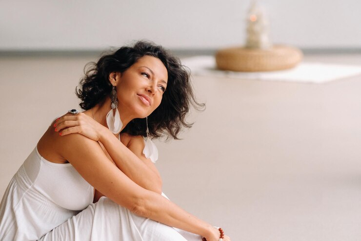 A woman in a white sundress in a bright interior. The concept of relaxation.