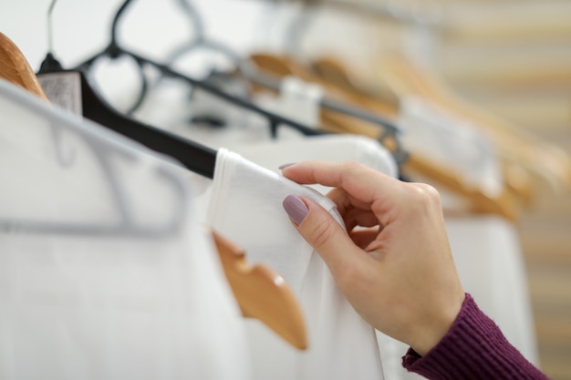 Abbigliamento bianco da donna sul gancio in negozio