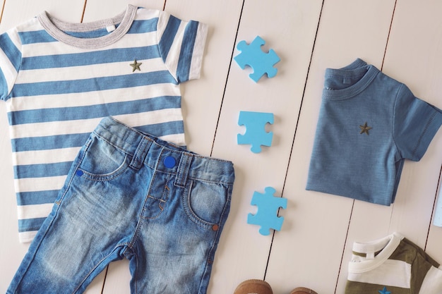 Abbigliamento e accessori per bambini piatti laici su sfondo di legno