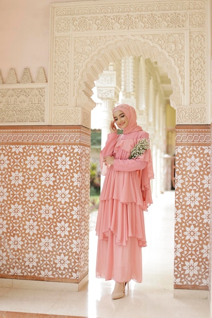 Abito da sposa malese o indonesiano bellezza o concetto eidul fitri Una donna musulmana che posa alla moschea