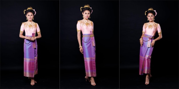 Abito Loykrathong di costume tradizionale tailandese o abito dorato del sud-est asiatico in donna asiatica con supporto decorativo esprimere un sorriso felice per il festival galleggiante di Loy Krathong su sfondo nero