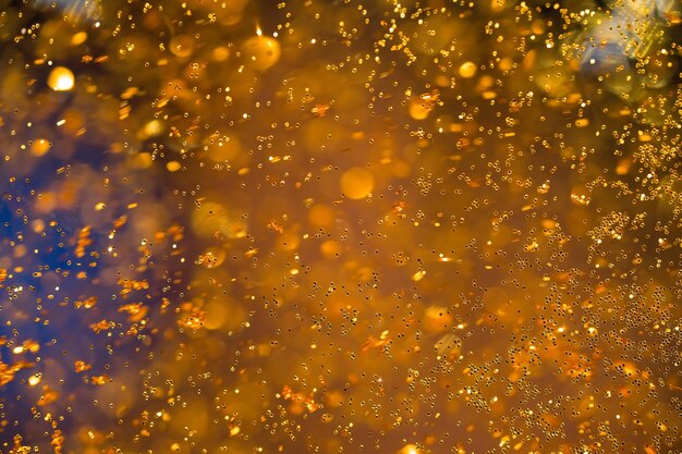 Abstract golden bokeh background defocused golden particles glittery and motion blur particles gold