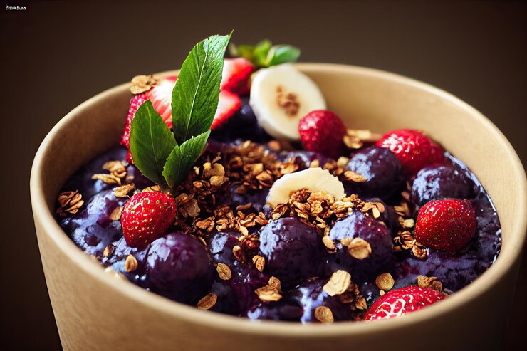 Açaí bowl with granola, tropical fruits, banana, strawberry, raspberry, condensed milk and cereal. Selective focus. Close up.