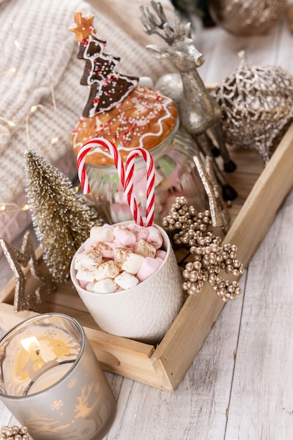 Accogliente composizione invernale con tazza e cioccolata calda con marshmallow.