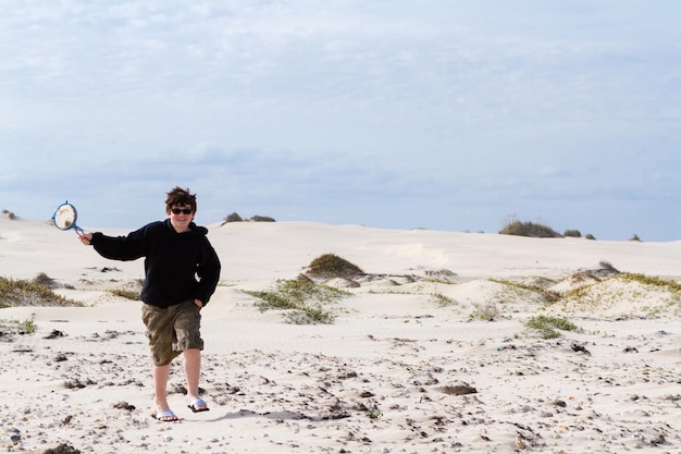 Adolescente che gioca nelle dune costiere.