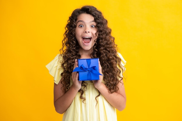 Adolescente emotivo bambino tenere regalo per il compleanno Ragazza bambino divertente con scatole regalo per celebrare il felice anno nuovo o Natale Adolescente eccitato felice emozioni stupite e felicissime