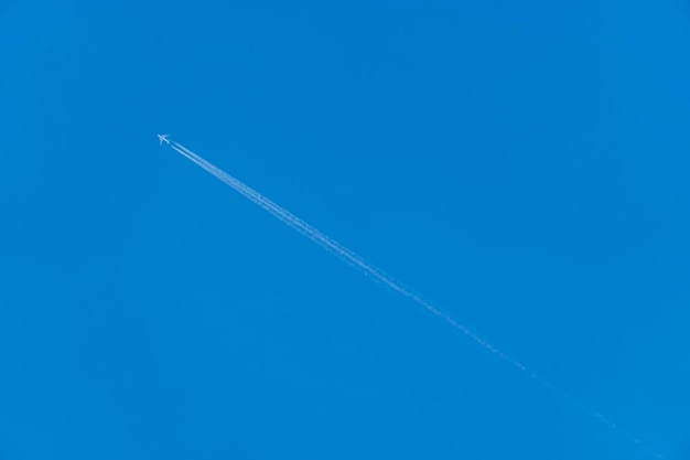 Aereo di linea con scia di vapore contro un cielo blu