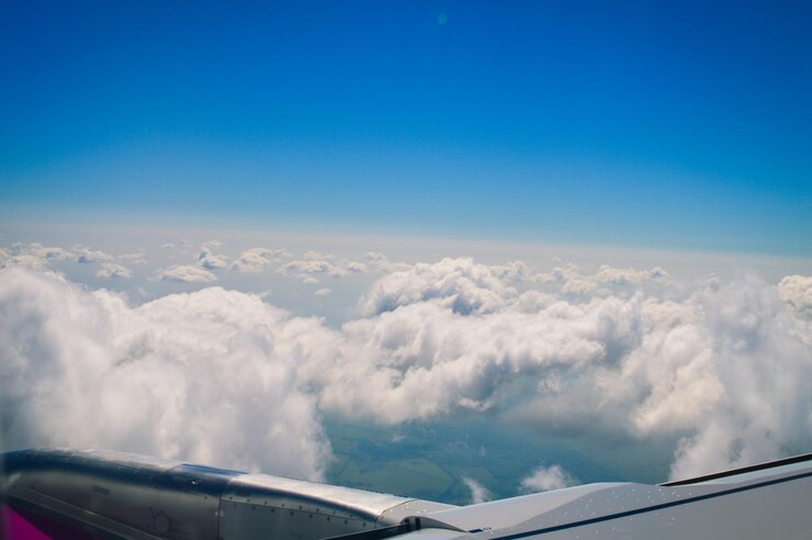 Photo aerial view of aircraft wing against blue sky