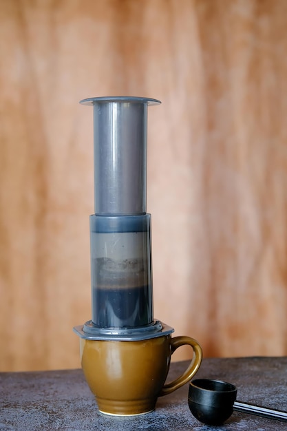 Aeropress Dispositivo per fare il caffè Una ragazza prepara il caffè americano con un Aeropress