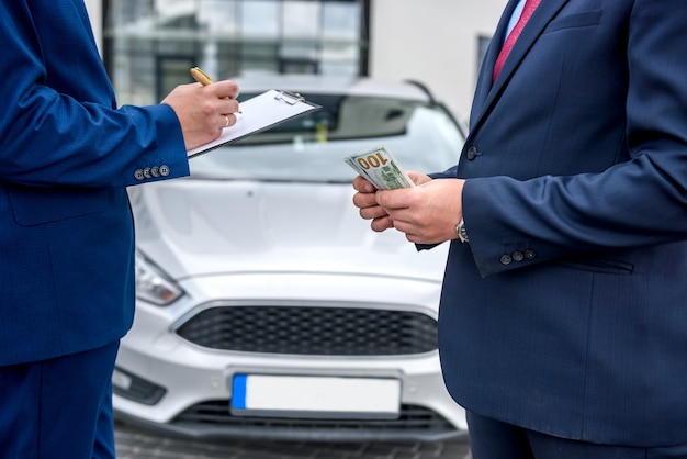 Affare di acquisto di auto tra due uomini all'aperto