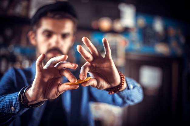 Affascinante barista femminile sta versando un drink in piedi vicino al bancone del bar in discoteca