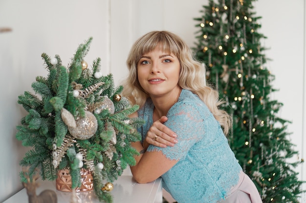 Affascinante ragazza con bel trucco sul viso in oro e bianco interni vacanze di Natale festa allegra con la famiglia