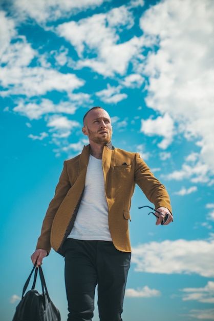 Affascinante uomo con occhiali da sole casual stile urbano faccia seria