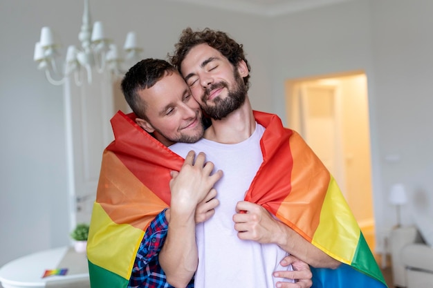 Affettuosa coppia gay maschile al chiuso Donna che abbraccia il suo ragazzo da dietro a casa Coppia gay che celebra il mese dell'orgoglio