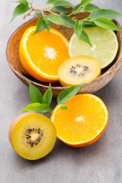 Agrumi misti limoni, arancia, kiwi, lime su un grigio