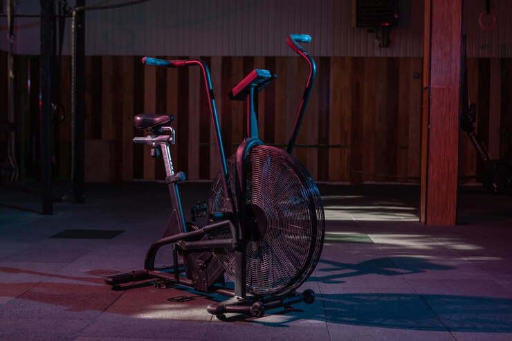 Airbike professional exercise bike with aerodynamic loading system in redblue neon light in a modern health class Cross training