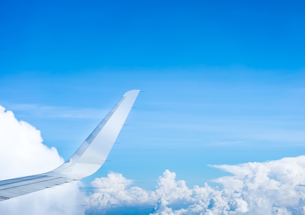 Ala dell&#39;aeroplano che vola sopra le nuvole e il cielo blu