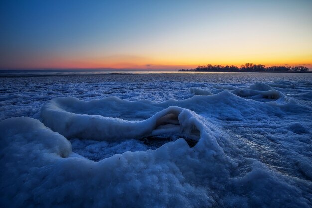 Alba e fiume ghiacciato. Bellissimo paesaggio invernale con lago al mattino. alba