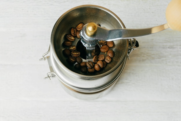 Alcuni chicchi di caffè in un macinacaffè metallico