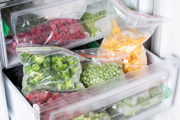 Alimenti congelati nel congelatore. Verdure surgelate, piatti pronti in freezer. Carne, cibo e verdure congelati. Dispensa