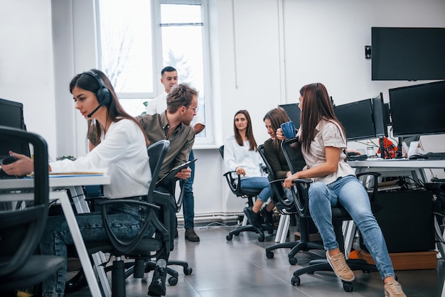 All'interno del call center. Giovani uomini d'affari che lavorano insieme nell'ufficio moderno.