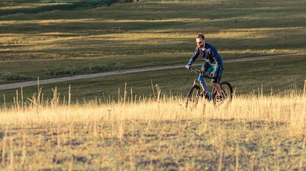 Alla conquista delle vette da ciclista in pantaloncini e maglia su una moderna bici in carbonio