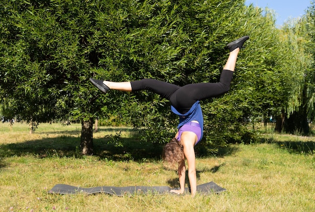 Allenatore, ragazza fitness femminile facendo esercizi in un parco verde.