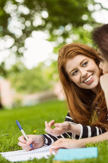 Allievi femminili rilassati con i libri in parco