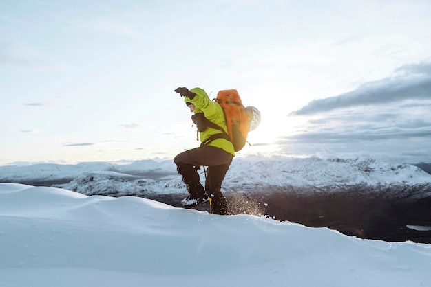 Alpinista arrampicata nella neve a Liathach Ridge, Scozia