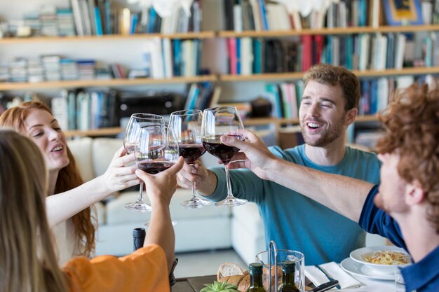 Amici brindando con vino rosso