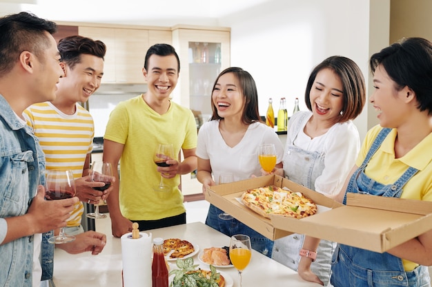 Amici che mangiano e bevono alla festa in casa