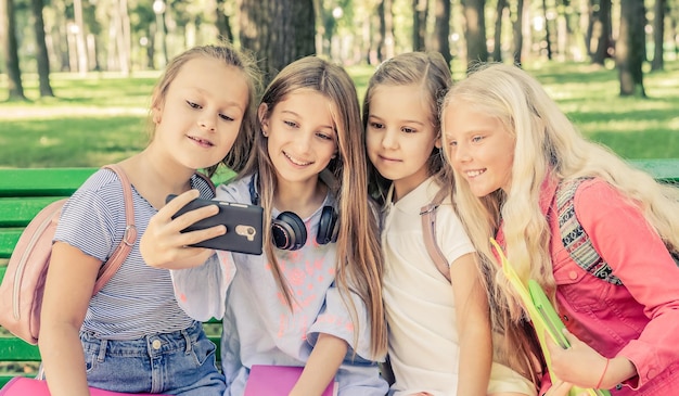 Amici che scattano foto insieme e si siedono nel parco