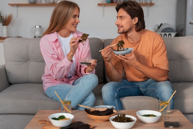 Amici di medio livello che mangiano snack alle alghe