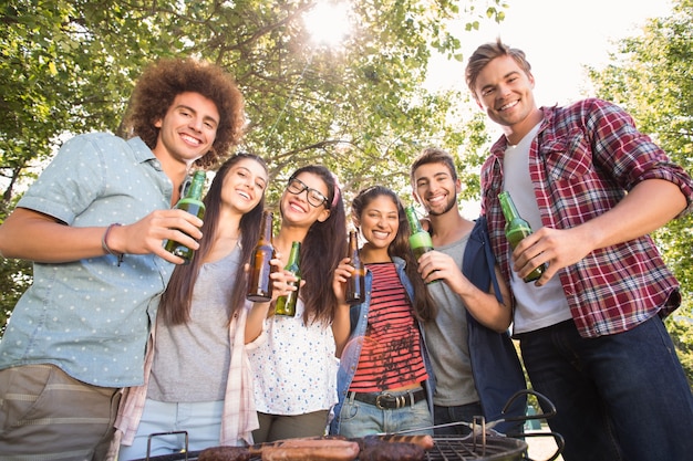 Amici felici nel parco con barbecue