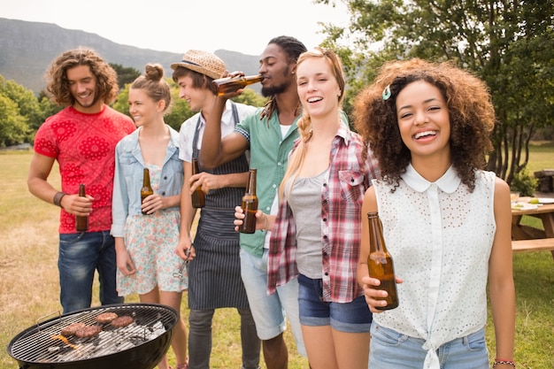 Amici felici nel parco con barbecue